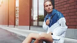 Young,Athlete,In,Windrunner,Sitting,On,The,Street,After,Good