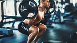 Ein Mann trainiert oberkörperfrei im Fitnessstudio