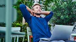 break,building,casual,colour,job,relaxed,urban Young businessman with laptop at an outdoor cafe in the city having a break