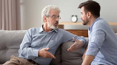 Serious,60s,Elderly,Father,And,Grown,Up,Adult,Son,Sitting