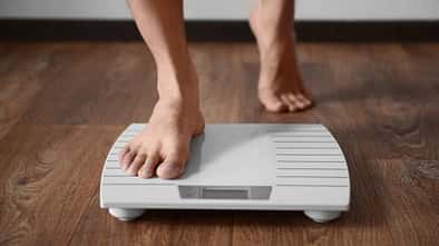 Man,Standing,On,Weight,Scale