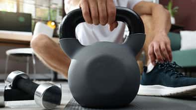 Mann nimmt eine Kettlebell in die Hand