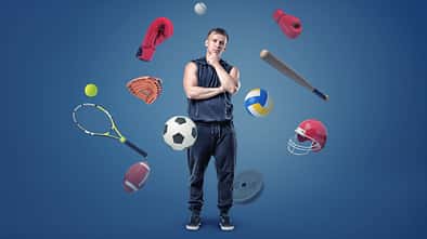 A,Thoughtful,Muscular,Man,Stands,Surrounded,By,Different,Sport,Gear