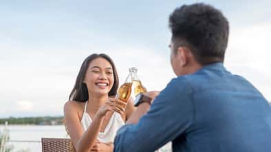 Two,Young,Attractive,People,Make,A,Toast,With,Their,Beer