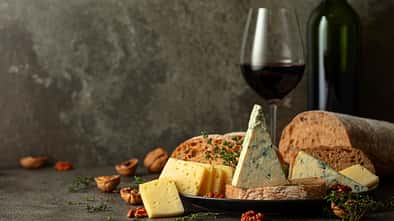 Cheese,,Bread,,Red,Wine,,And,Walnuts,On,A,Kitchen,Table.
