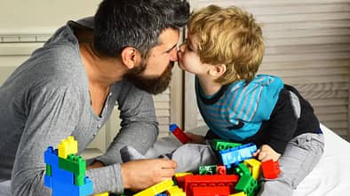Vater und Sohn spielen mit Bauklötzen