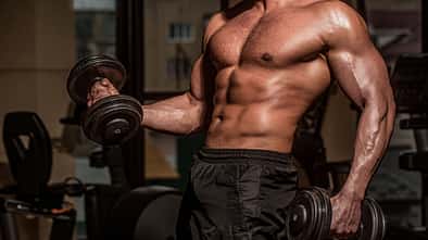 Power,Athletic,Man,In,Training,Pumping,Up,Muscles,With,Dumbbell.