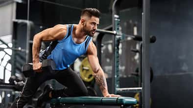 Strength,Workout.,Handsome,Athlete,Working,Out,With,Dumbbell,At,Gym,