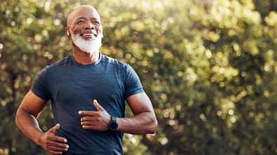 Happy,Black,Man,Running,In,Park,With,Music,,Smile,And