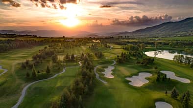 Golf course beautiful Aerial view of golf field landscape with sunset view.