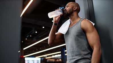 Side,View,Portrait,Of,Muscular,Black,Man,Drinking,Water,After
