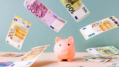 Piggy bank and falling European Union currency