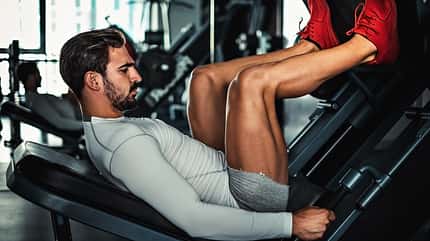 muscular,handsome,strong,strength,young,caucasian,exercise,train Man,Focused,On,Training,Legs,On,The,Machine,In,The
