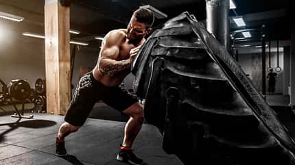 muscular,big,activity,strength,young,caucasian,exercise,effort,t Shirtless,Man,Flipping,Heavy,Tire,At,Gym
