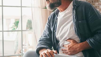 belly,mature,abdomen,caucasian,indigestion,stomach,sick,unwell,h Man,Suffering,With,Severe,Stomach,Pain,Sitting,At,Home.,Hand