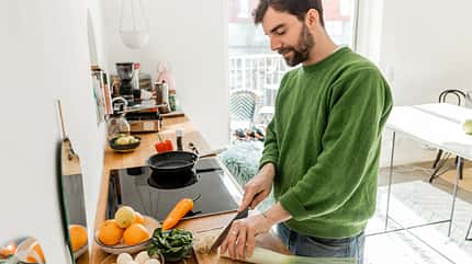 cut,caucasian,bearded,spacious,worktop,house,vegetables,contentm Young,Bearded,Man,In,Casual,Clothes,Cutting,Leek,Near,Eggs