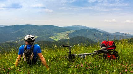 baden-wurttemberg,belchen,black forest,caucasian appearance,clouds,colour image,field,real Rear view of man relaxing on grass and looking at mountains