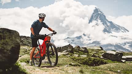 Mountain biker looking back at majestic view of Matterhorn Mountain biker looking back at majestic view of Matterhorn