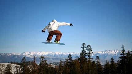 Snowboarder springt hoch in die Luft Snowboarder springt hoch in die Luft