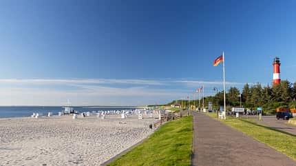 scenic,family time,recreational area,outdoor fun,summer activities,calm waters,blue sky,nature walk,shoreline,sunny day,marine environment,local exploration,flagpoles,sylt,vacation,coastal scenery,outdoor,landscape,beach walk,hornum beach,coastal,flags,schleswig holstein,idyllic location,seaside,beach chairs,local culture,greenery,beach activities,sightseeing,leisure,ocean view,relaxation station,beach outing,peaceful,walking path Hornum beach, Sylt, Schleswig Holstein, Germany, Europe