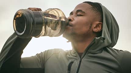 Mann trinkt aus einer Wasserflasche Mann trinkt aus einer Wasserflasche