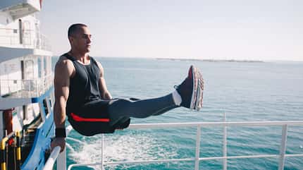 Ein Mann macht Fitnessübungen am Schiffsdeck Ein Mann macht Fitnessübungen am Schiffsdeck