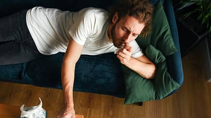 The sick guy lies on the couch and takes a pill. Dry wipes. Young guy. Casual style. Glass of water. Vitamins and dietary supplements. Disease. The sick guy lies on the couch and takes a pill. Dry wipes. Young guy. Casual style. Glass of water. Vitamins and dietary supplements. Disease.