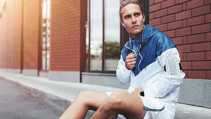 Young,Athlete,In,Windrunner,Sitting,On,The,Street,After,Good
