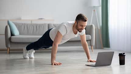 Happy,Middle-aged,Man,In,Sportswear,Doing,Push-ups,,Using,Laptop,,Having