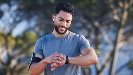 Runner,With,Fitness,Smart,Watch,,App,And,Check,Running,Time
