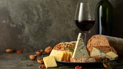 Cheese,,Bread,,Red,Wine,,And,Walnuts,On,A,Kitchen,Table.