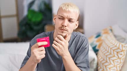 bed,handsome,reason,young,caucasian,idea,confident,reasoning,pen Young,Caucasian,Man,Holding,Condom,Sitting,On,Bed,Serious,Face