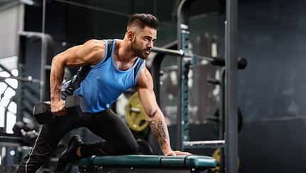Strength,Workout.,Handsome,Athlete,Working,Out,With,Dumbbell,At,Gym,