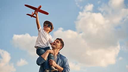 Orange,Colored,Toy,Plane,In,Hands.,Father,And,Little,Son