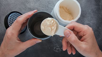 Top,View,Of,Man,Adding,Protein,Powder,To,Protein,Shaker