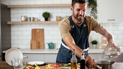 Happy,Man,In,Kitchen.,Young,Man,Preparing,Delicious,Food.