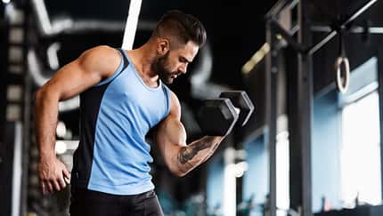 Muscular,Sportsman,With,Strong,Body,Lifting,Heavy,Dumbbell,,Empty,Space