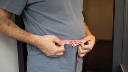 Overweight,Man,Measures,His,Waist,With,Measuring,Tape.,Fat,Belly