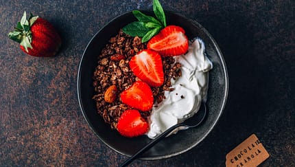 Chocolate,Granola,With,Irish,Skyr,And,Strawberries,On,Dark,Background.