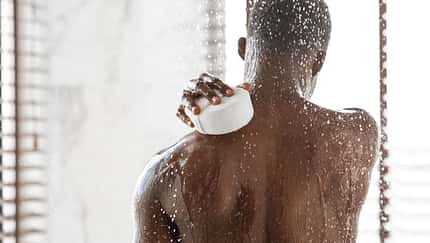 Unrecognizable,Black,Man,Washing,Back,With,Sponge,Taking,Refreshing,Shower
