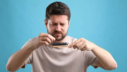 Sad,Man,Taking,His,Lost,Hair,From,Brush,On,Light