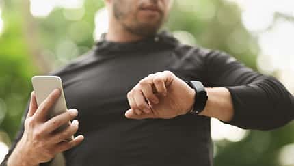 Male athlete using fitness app on his smartwatch