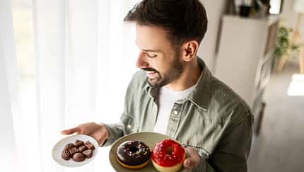 Happy Guy Picking His Favorite Sweet Snack Happy Guy Picking His Favorite Sweet Snack