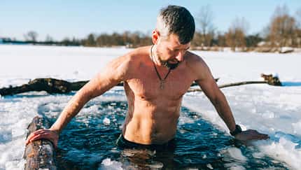 Ein Mann nimmt ein Eisbad in einem See