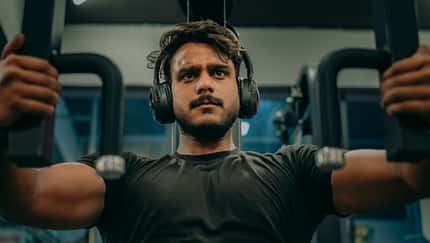 Determined Fitness Enthusiast Working Out on Chest Press Machine – Intense Gym Training Concept Determined Fitness Enthusiast Working Out on Chest Press Machine – Intense Gym Training Concept