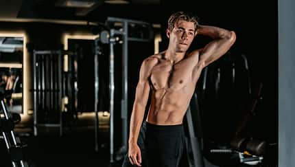 Young Man Flexing Muscles At The Gym Young Man Flexing Muscles At The Gym