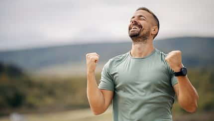 Man celebrating achievement reaching success outdoors Man celebrating achievement reaching success outdoors
