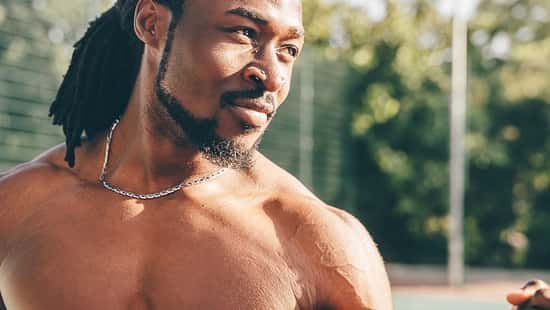 Young and healthy athletic man is exercising outdoors in Summer shirtless