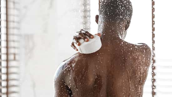 Unrecognizable,Black,Man,Washing,Back,With,Sponge,Taking,Refreshing,Shower