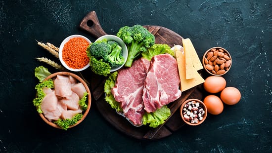 Auswahl an proteinreichen Lebensmitteln auf einem Brett 